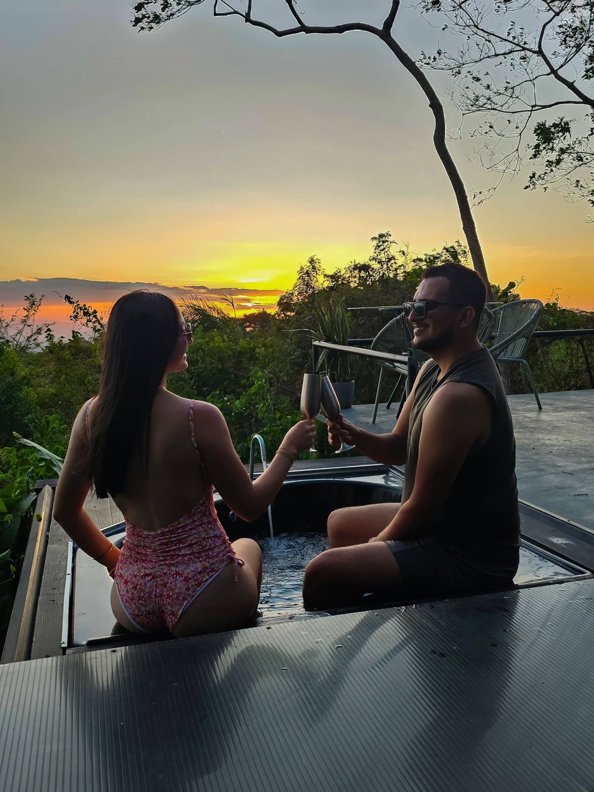 Couple toasting in the private terrace jacuzzi at sunset — glamping with private jacuzzi in Costa Rica